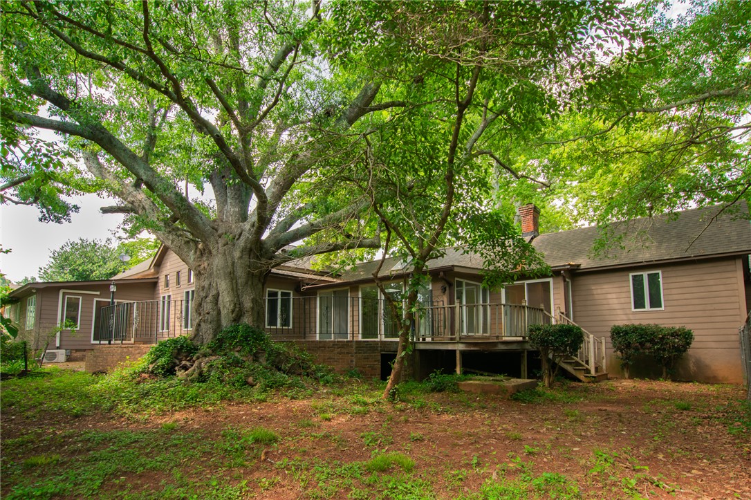 200 Chenault Road Townville, SC 29689 - Photo 46 of 47 Mature trees frame this inviting residence, offering privacy and a tranquil backyard escape.