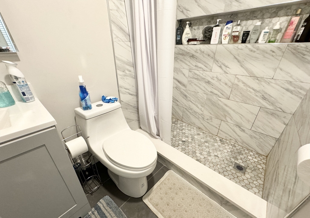 20 Howell Street, Unit 3 Boston, MA 02125 - Photo 5 of 6 a white toilet sitting next to a bathroom sink