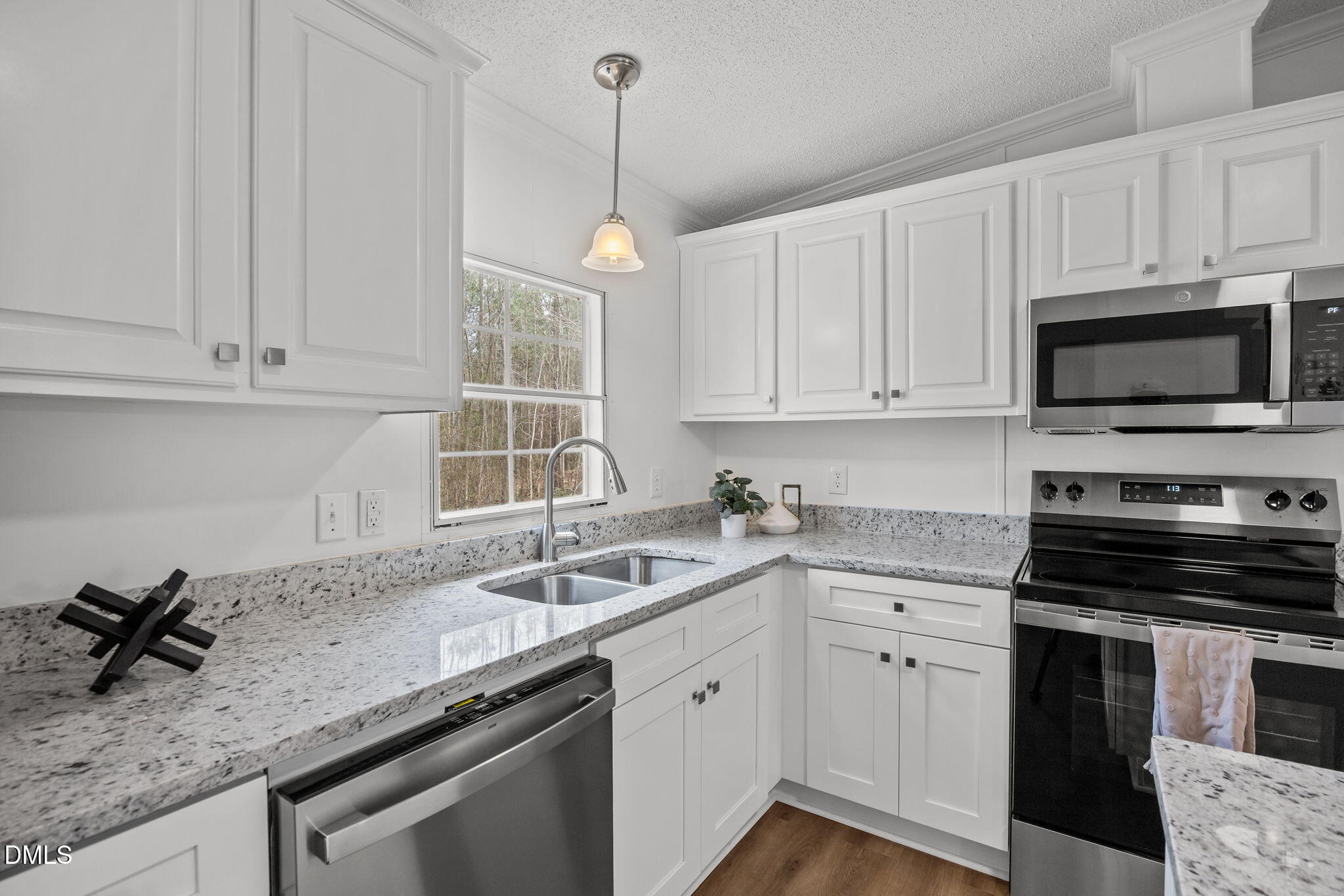 35 Athens Court Cameron, NC 28326 - Photo 15 of 44 a kitchen with granite countertop a sink stainless steel appliances and cabinets