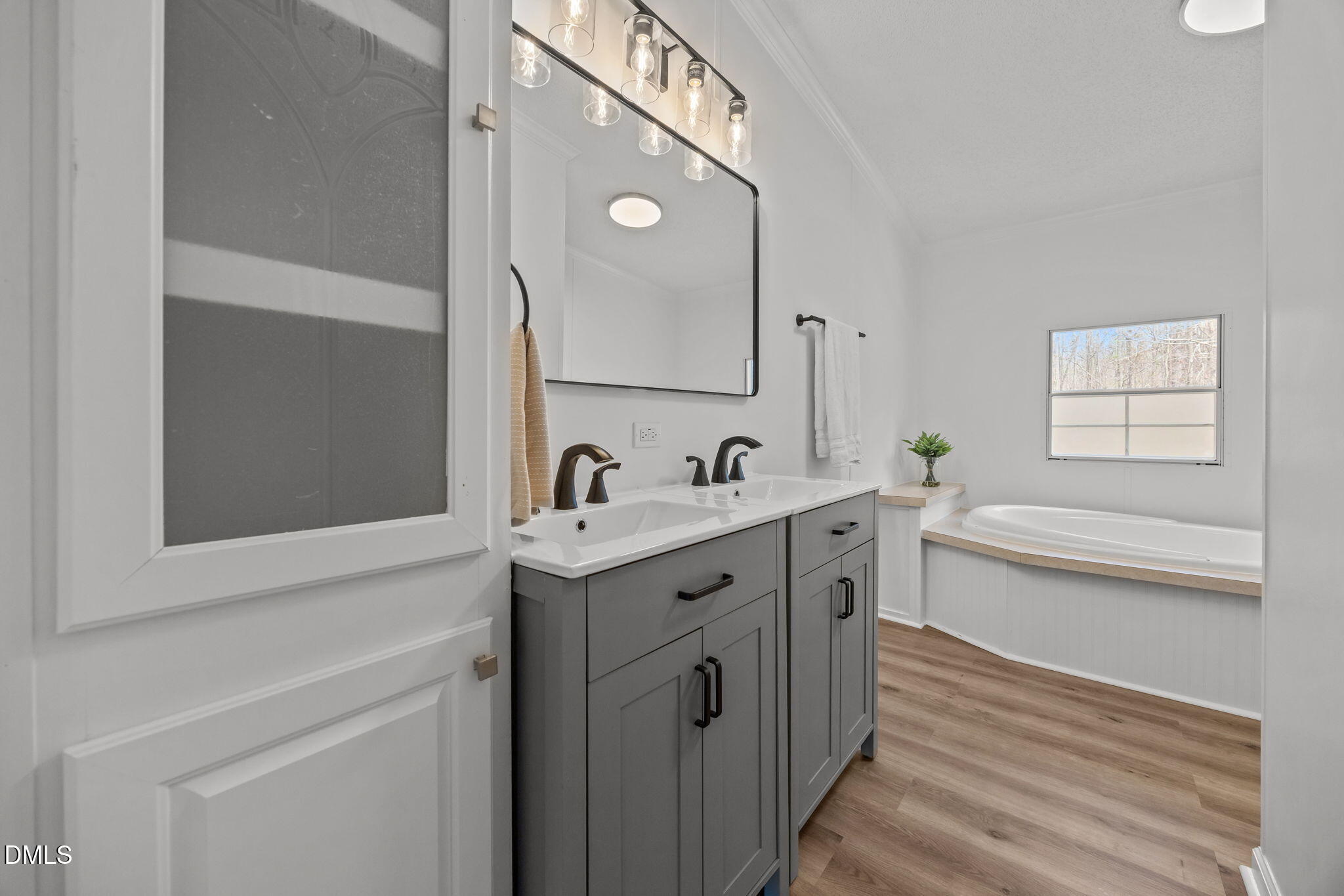 35 Athens Court Cameron, NC 28326 - Photo 23 of 44 a spacious bathroom with a double vanity sink a mirror and a bathtub