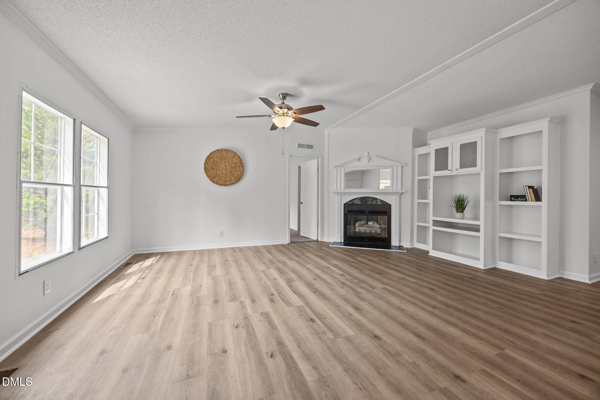 35 Athens Court Cameron, NC 28326 - Photo 6 of 44 wooden floor fireplace and windows in an empty room