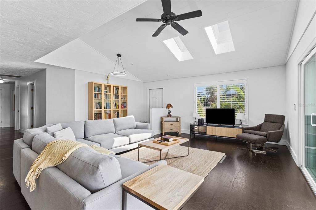 315 Spring Avenue Anna Maria, FL 34216 - Photo 11 of 63 a living room with furniture and a flat screen tv