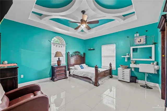 a spacious bedroom with a bed and ceiling fan