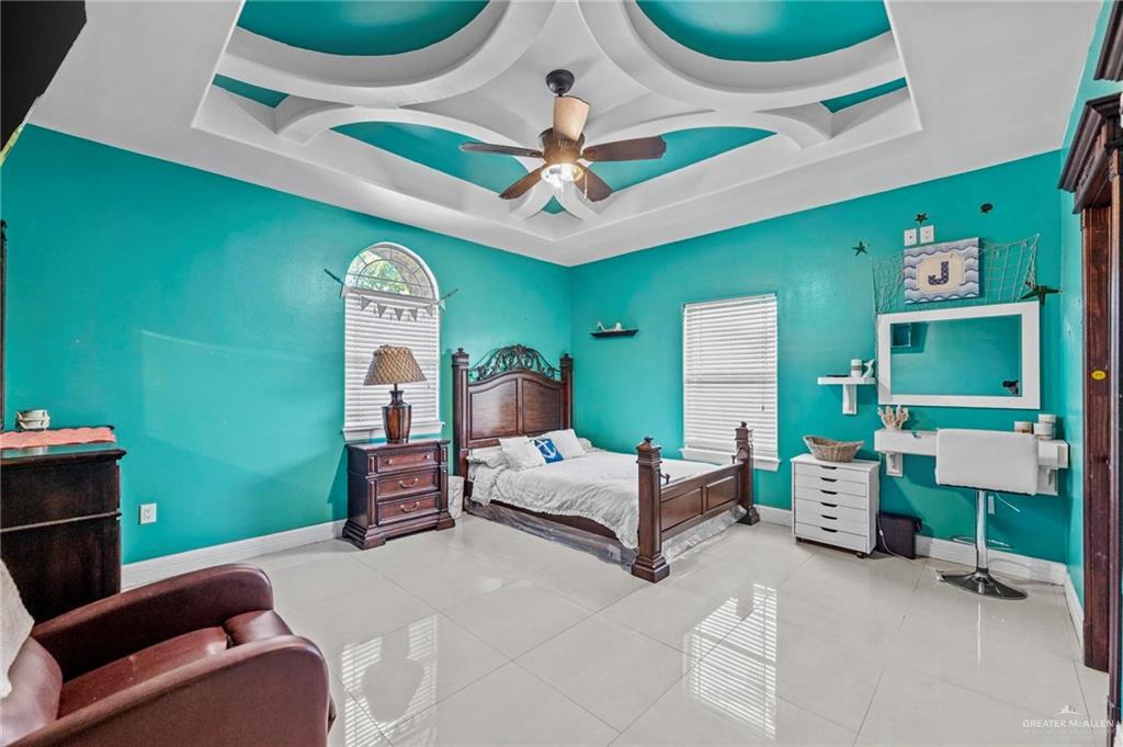 678 La Mesa Street Rio Grande City, TX 78582 - Photo 13 of 35 a bedroom with a bed and a chandelier