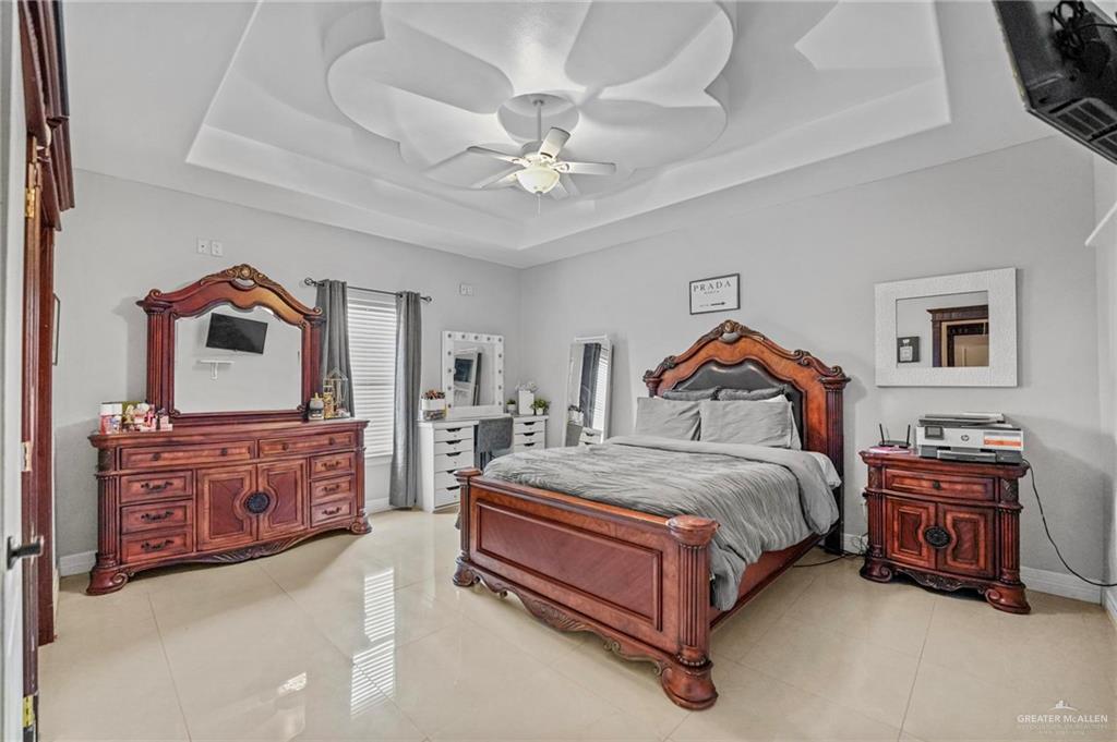 678 La Mesa Street Rio Grande City, TX 78582 - Photo 14 of 35 a spacious bedroom with a bed and ceiling fan