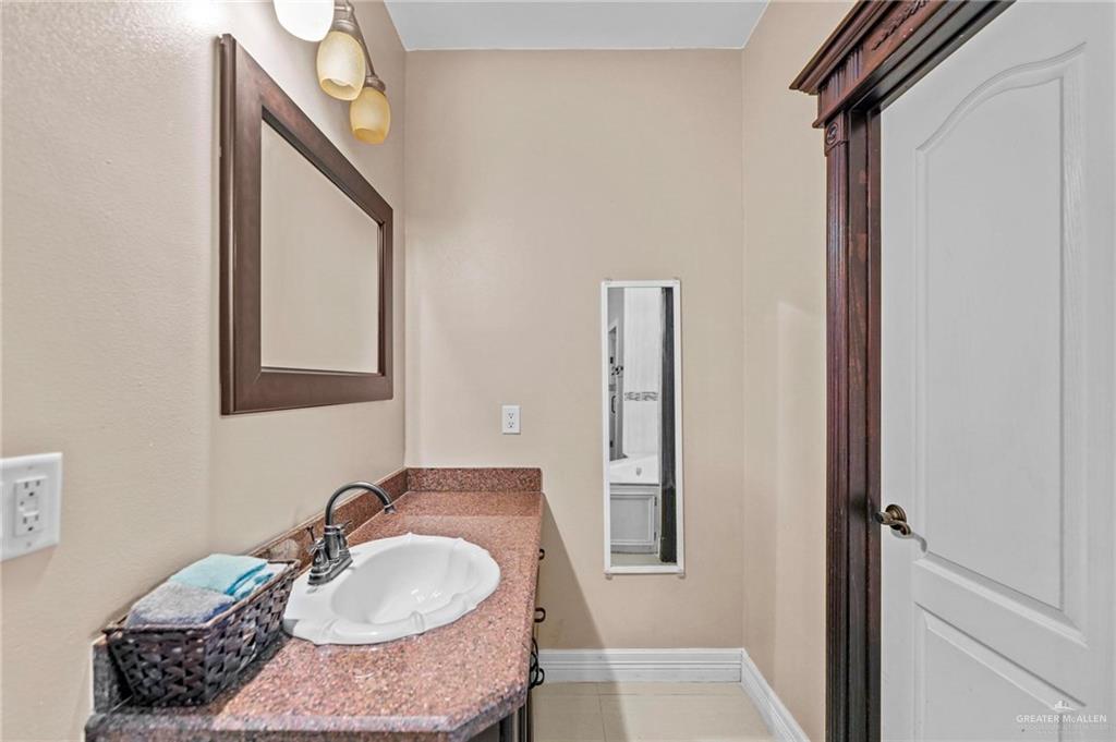 678 La Mesa Street Rio Grande City, TX 78582 - Photo 16 of 35 a bathroom with a sink and a mirror