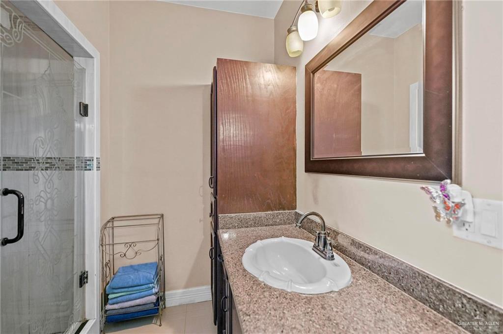 678 La Mesa Street Rio Grande City, TX 78582 - Photo 18 of 35 a bathroom with a sink and mirror