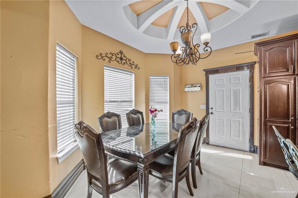 678 La Mesa Street Rio Grande City, TX 78582 - Photo 20 of 35 a dining room with furniture and chandelier