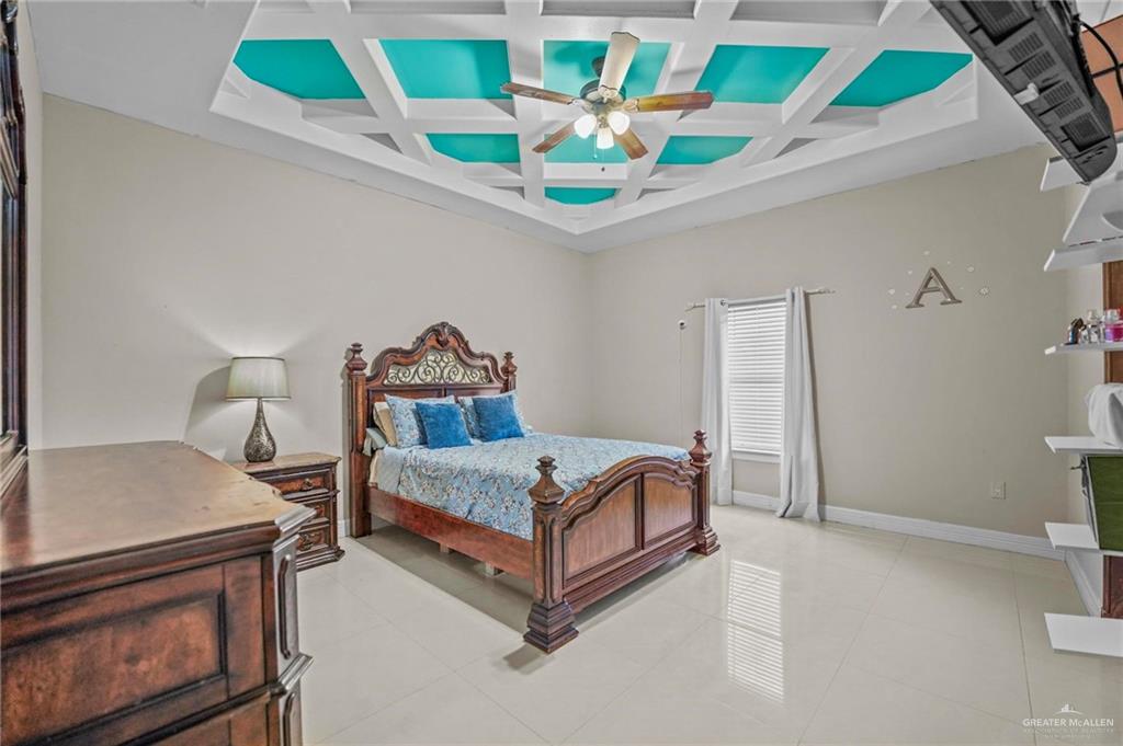 678 La Mesa Street Rio Grande City, TX 78582 - Photo 23 of 35 a bedroom with a bed a stove and a potted plant