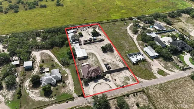 an aerial view of a house with outdoor space