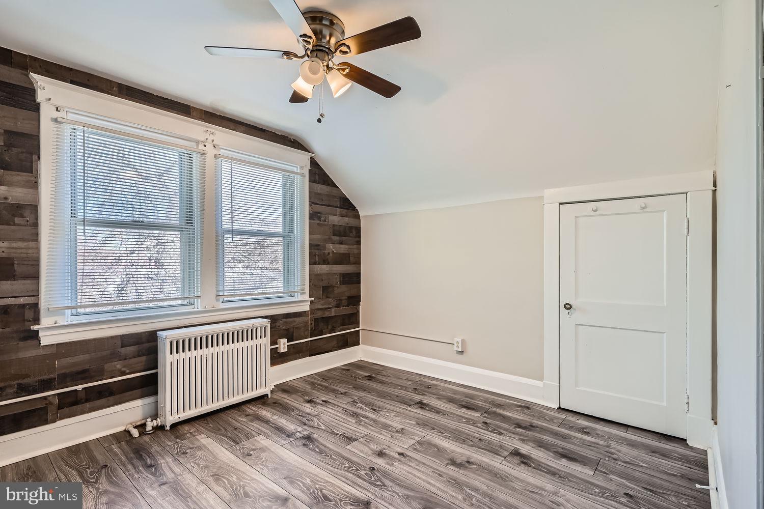2328 Sparrows Point Road Sparrows Point, MD 21219 - Photo 12 of 28 an empty room with wooden floor fan and windows