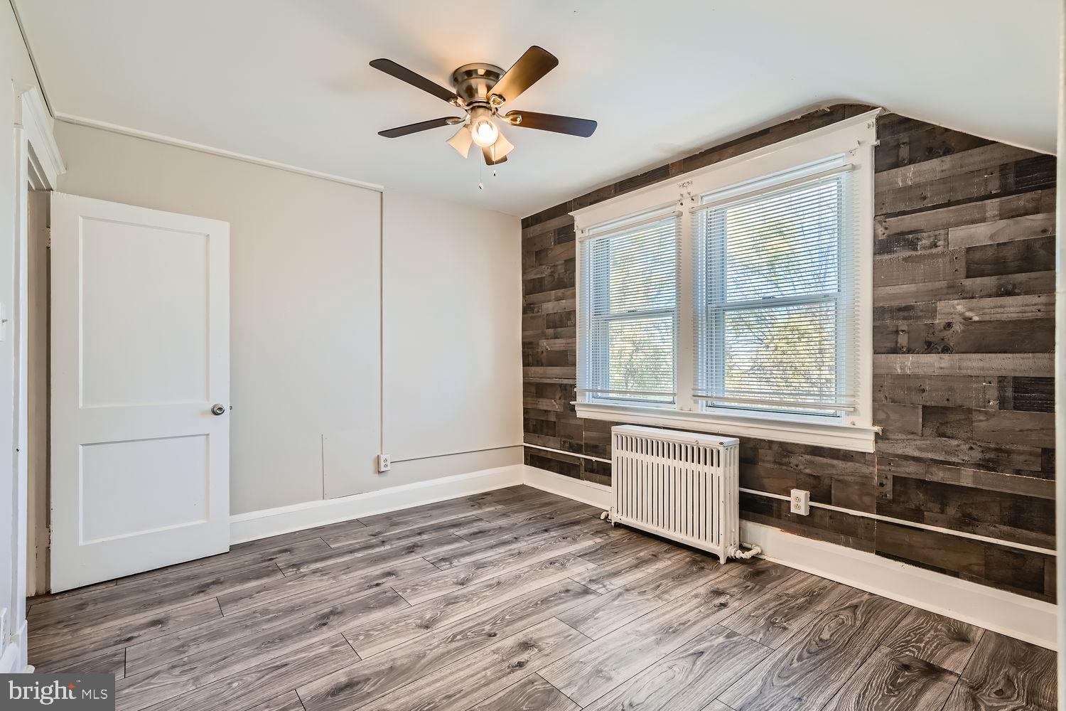 2328 Sparrows Point Road Sparrows Point, MD 21219 - Photo 13 of 28 wooden floor in an empty room with a window