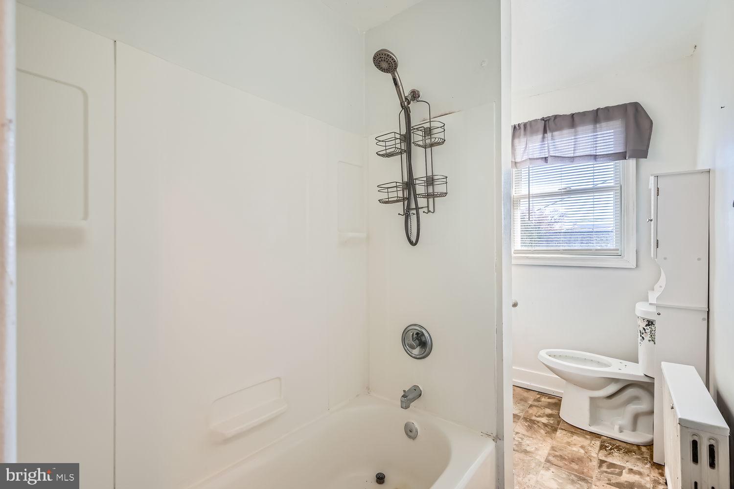 2328 Sparrows Point Road Sparrows Point, MD 21219 - Photo 14 of 28 a bathroom with a granite countertop bathtub shower sink and toilet