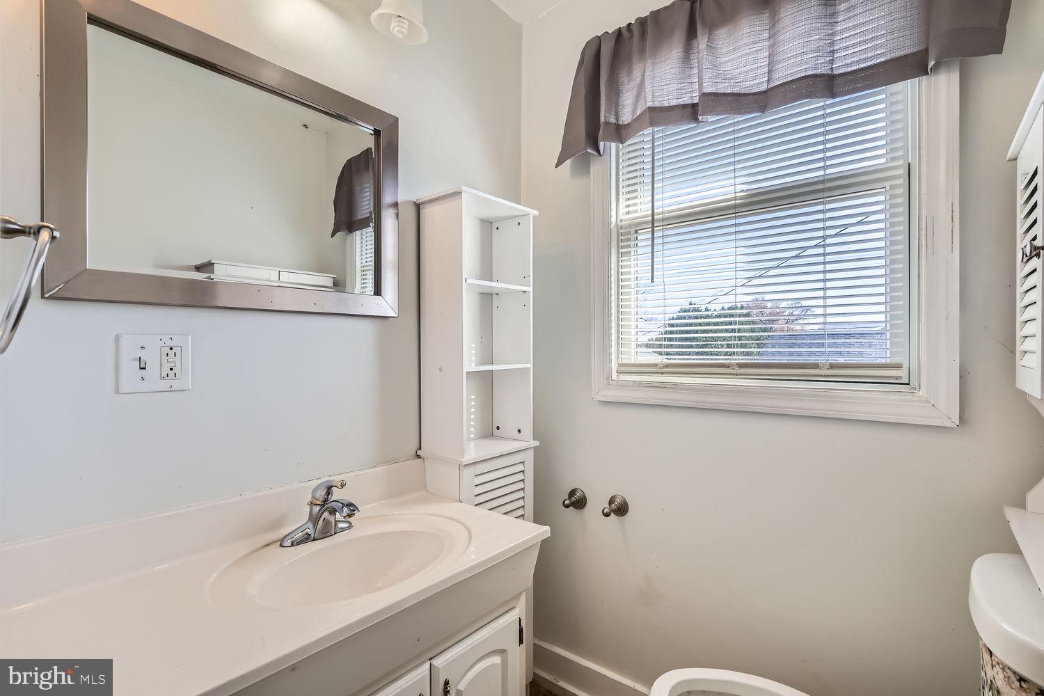 2328 Sparrows Point Road Sparrows Point, MD 21219 - Photo 15 of 28 a bathroom with a sink toilet and mirror