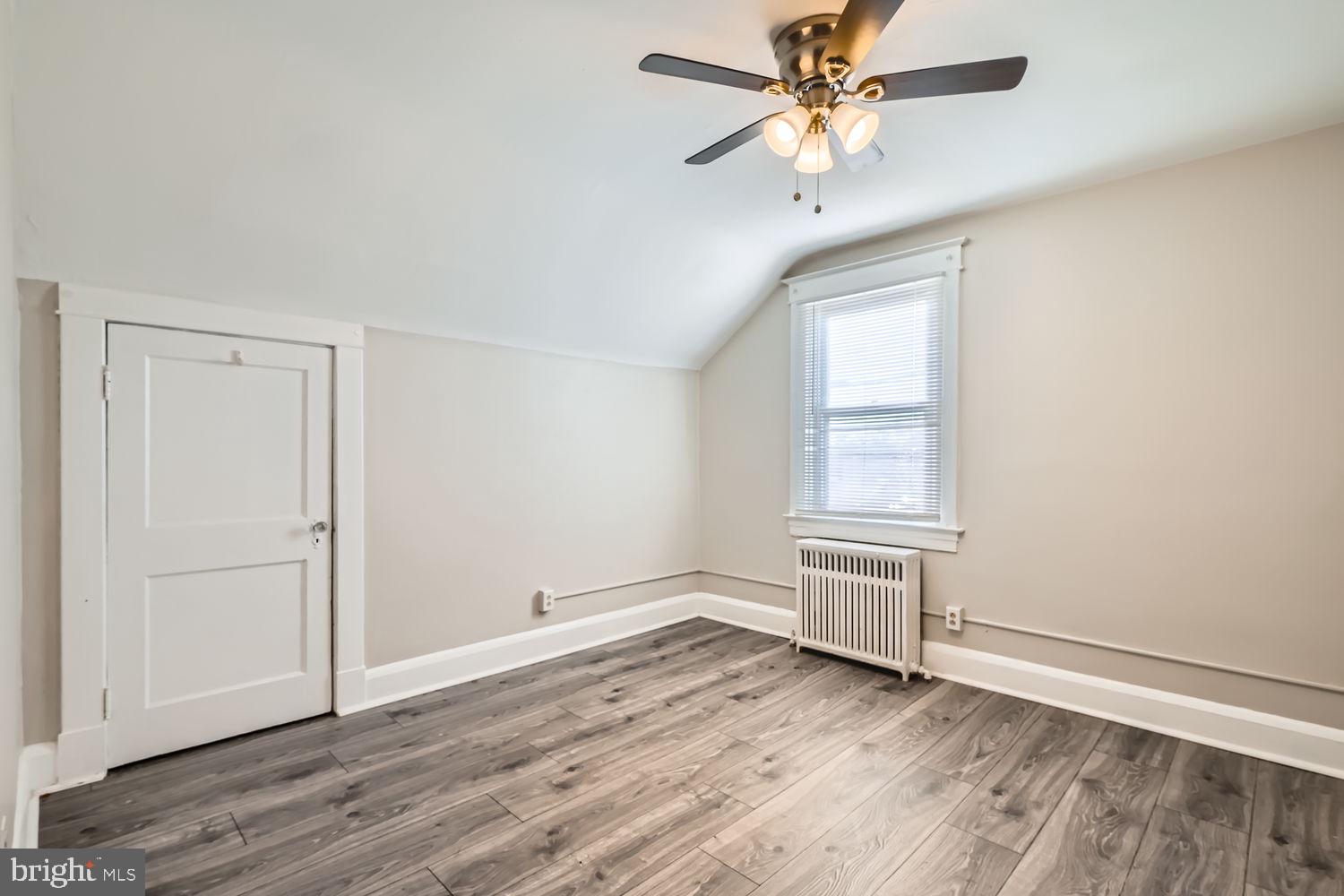 2328 Sparrows Point Road Sparrows Point, MD 21219 - Photo 16 of 28 wooden floor in an empty room with a window