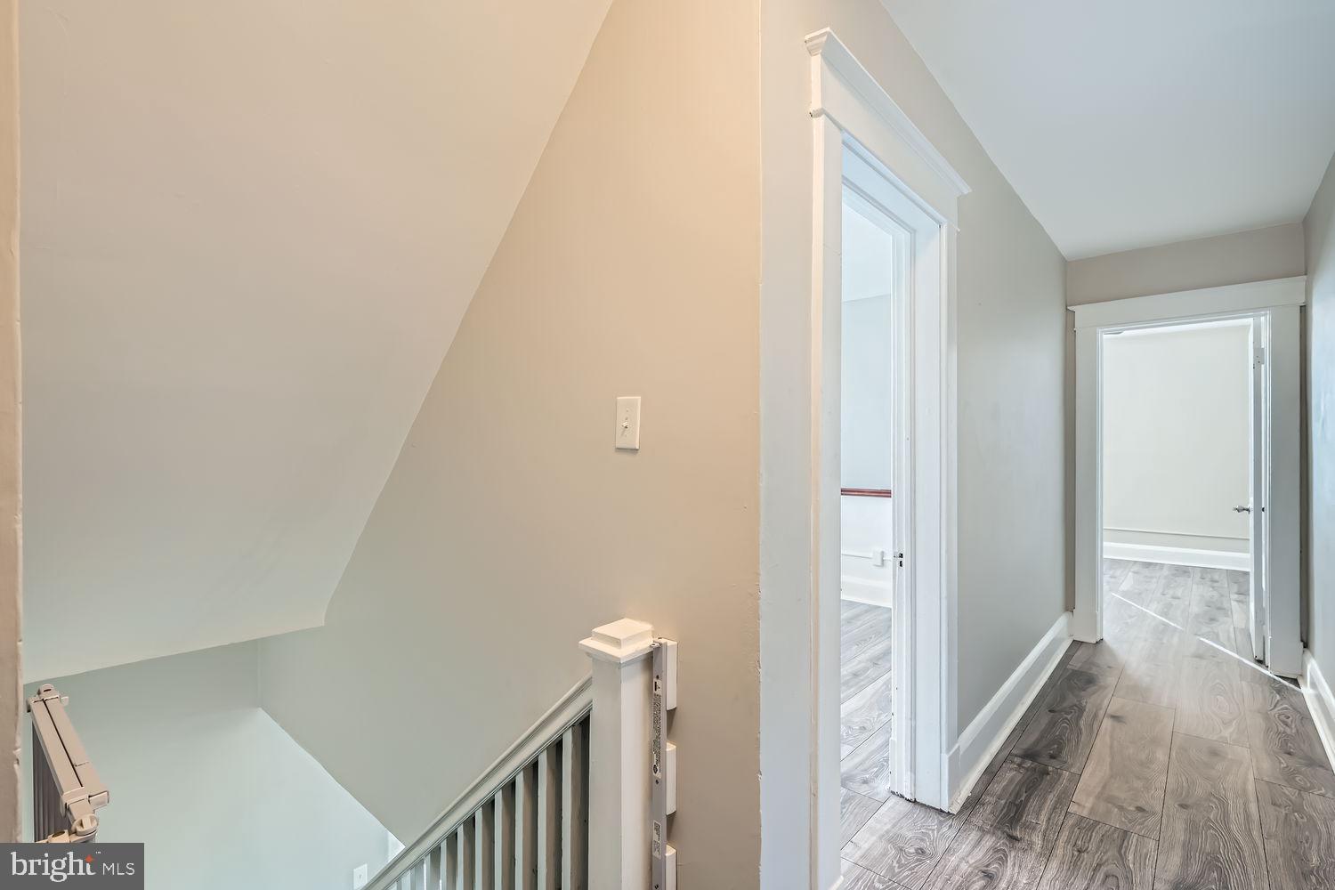 2328 Sparrows Point Road Sparrows Point, MD 21219 - Photo 18 of 28 a view of a hallway with wooden floor and staircase