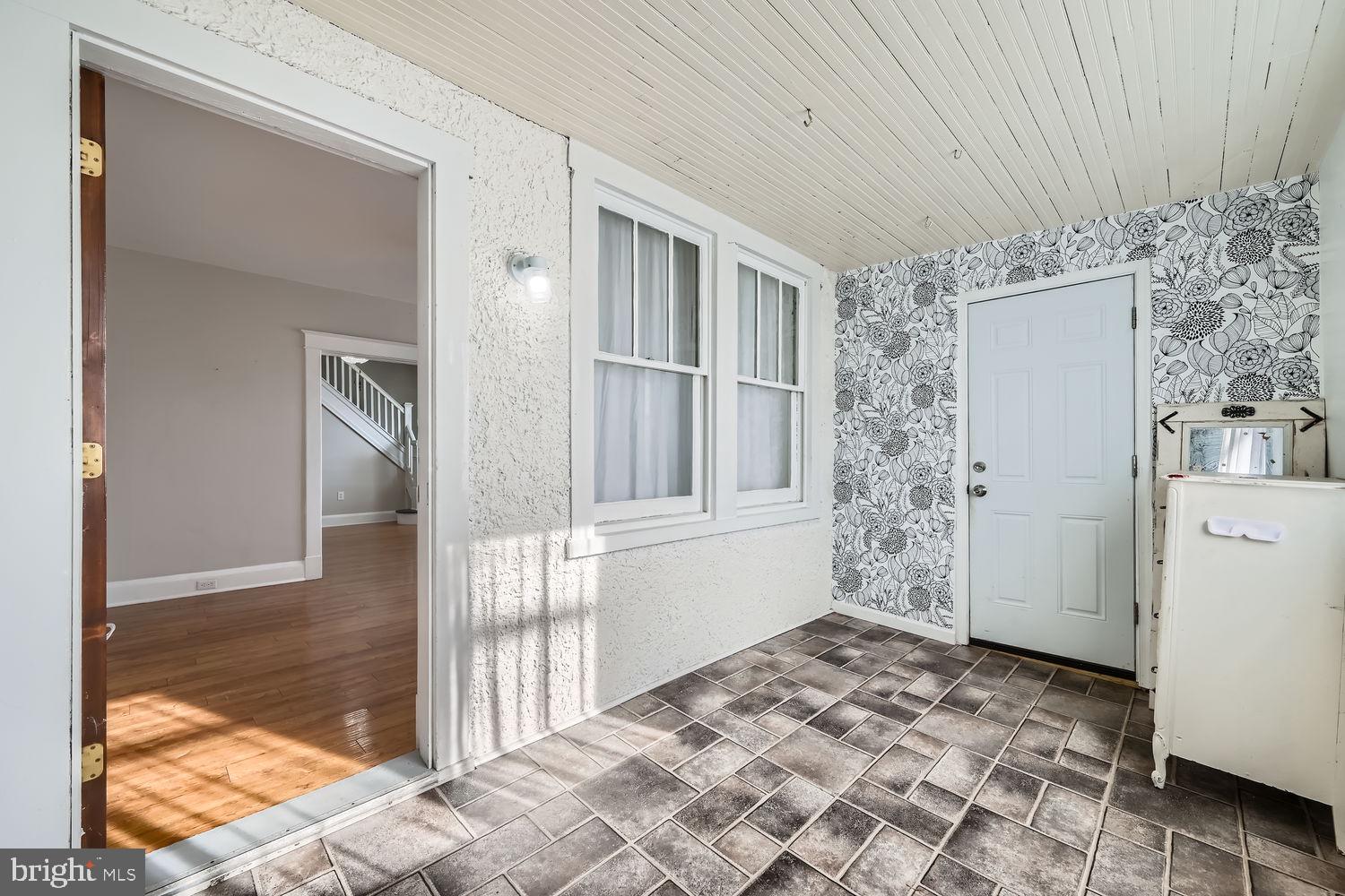 2328 Sparrows Point Road Sparrows Point, MD 21219 - Photo 23 of 28 a view of a hallway to a livingroom with furniture and front door