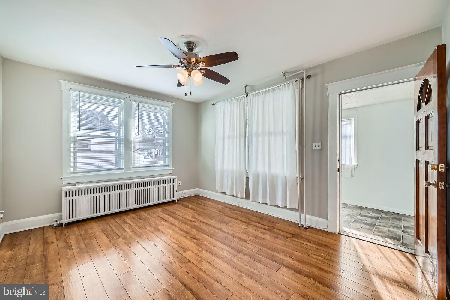 2328 Sparrows Point Road Sparrows Point, MD 21219 - Photo 5 of 28 an empty room with wooden floor fan and windows