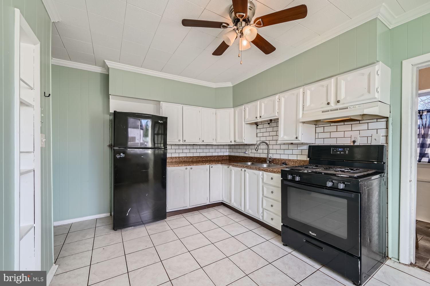 2328 Sparrows Point Road Sparrows Point, MD 21219 - Photo 8 of 28 a kitchen with cabinets and stainless steel appliances
