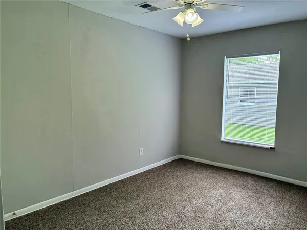 a view of a backyard with barn and large trees