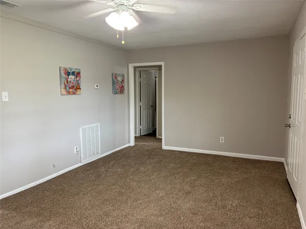a white kitchen with sink and cabinets