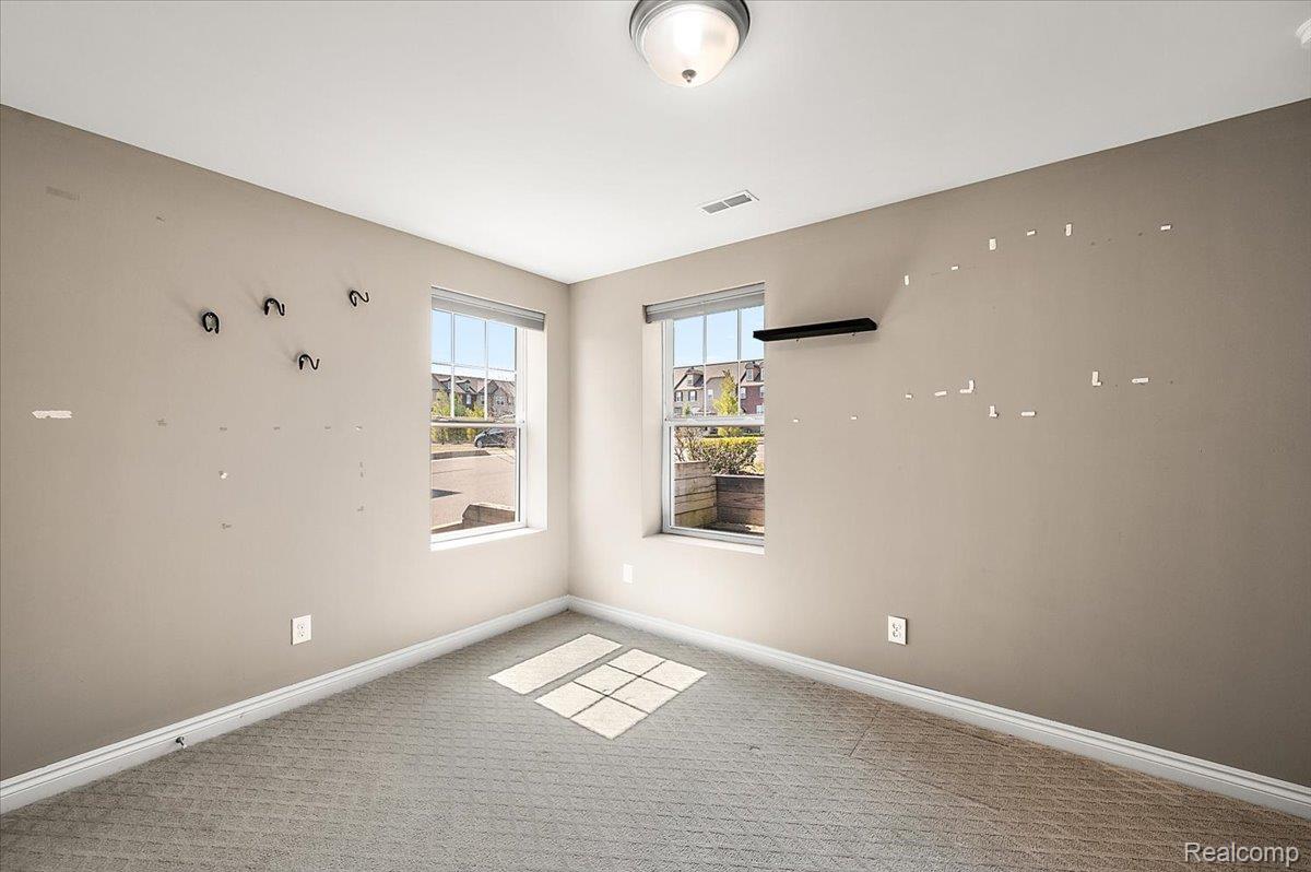 2877 Hartwick Drive Rochester, MI 48307 - Photo 42 of 44 Unfurnished room featuring baseboards and light carpet