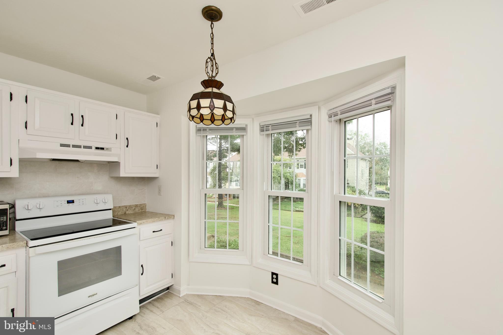 1448 Orleans Court Crofton, MD 21114 - Photo 15 of 33 a kitchen with stainless steel appliances granite countertop a stove a sink and a refrigerator