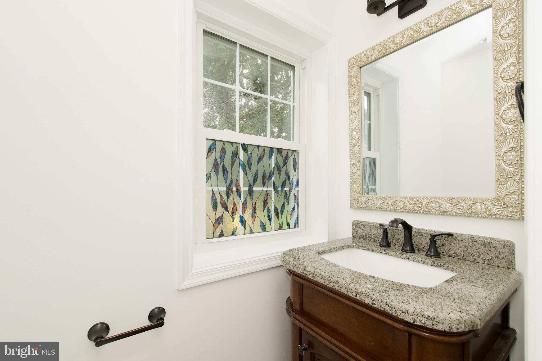 1448 Orleans Court Crofton, MD 21114 - Photo 16 of 33 a bathroom with a granite countertop sink and a mirror