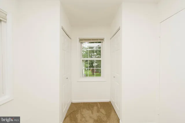 a bathroom with a granite countertop shower sink vanity and toilet