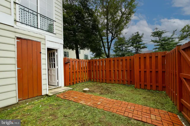 a view of a house with a wooden fence