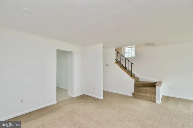 a view of an empty room with stairs