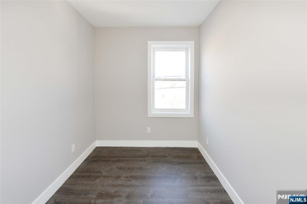 7 Watsessing Avenue, Unit 2R Bloomfield, NJ 07003 - Photo 12 of 14 an empty room with wooden floor and windows