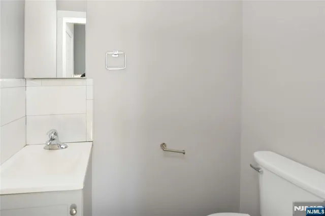 a bathroom with a sink a toilet and mirror