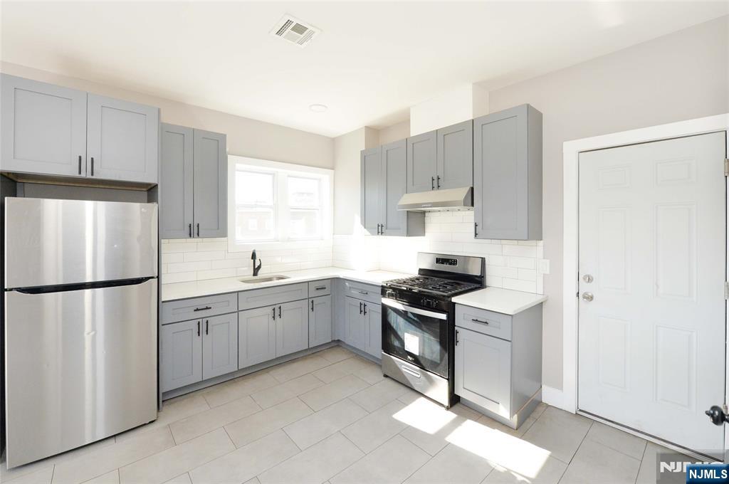 7 Watsessing Avenue, Unit 2R Bloomfield, NJ 07003 - Photo 3 of 14 a kitchen with cabinets appliances and a window
