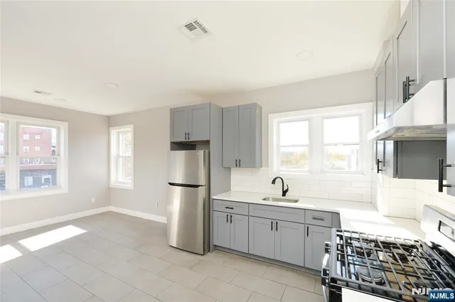 a kitchen with a sink and a refrigerator