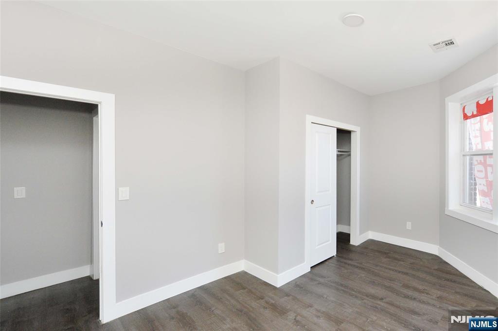 7 Watsessing Avenue, Unit 2R Bloomfield, NJ 07003 - Photo 7 of 14 an empty room with wooden floor and windows
