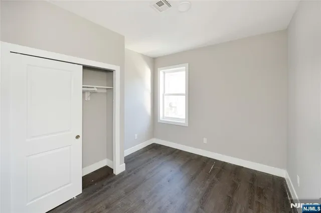 an empty room with wooden floor