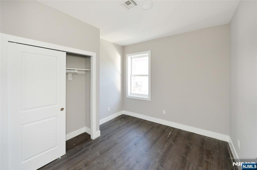 7 Watsessing Avenue, Unit 2R Bloomfield, NJ 07003 - Photo 9 of 14 an empty room with wooden floor