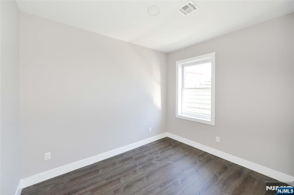 7 Watsessing Avenue, Unit 2R Bloomfield, NJ 07003 - Photo 10 of 14 an empty room with wooden floor and window