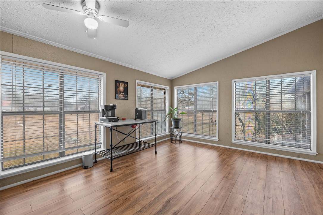 324 Stirrup Road Victoria, TX 77905 - Photo 12 of 40 an empty room with wooden floor and windows