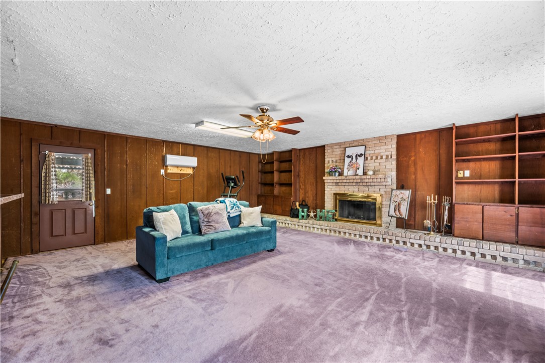 324 Stirrup Road Victoria, TX 77905 - Photo 15 of 40 a living room with furniture a fireplace and a large window