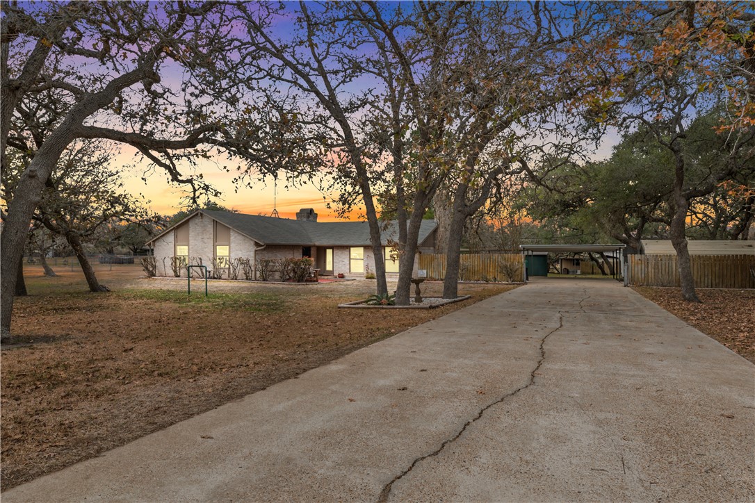 324 Stirrup Road Victoria, TX 77905 - Photo 2 of 40 a view of house with outdoor space and trees