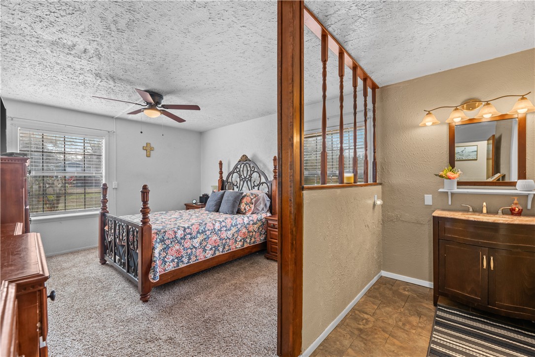 324 Stirrup Road Victoria, TX 77905 - Photo 21 of 40 a bedroom with a bed and wooden floor