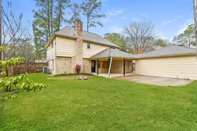 a view of a house with a yard and sitting area