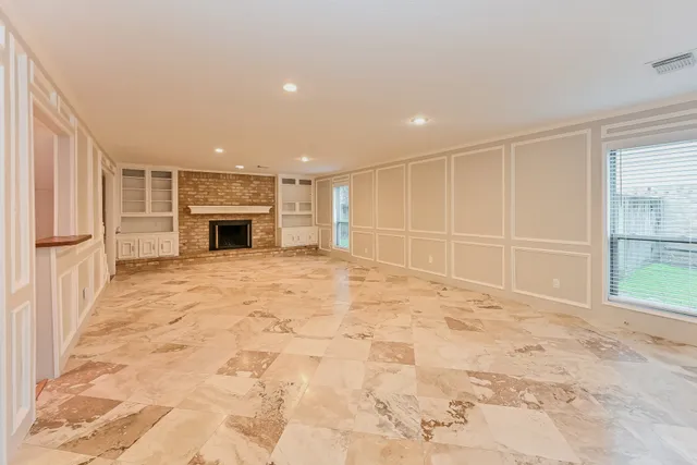 a view of an empty room with a fireplace