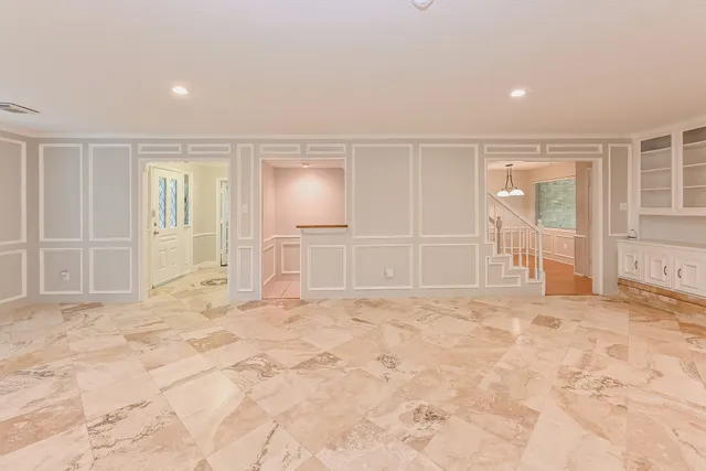 a view of empty room with wooden floor and cabinet