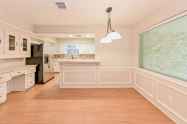a view of a kitchen with a stove cabinets and a wooden floor