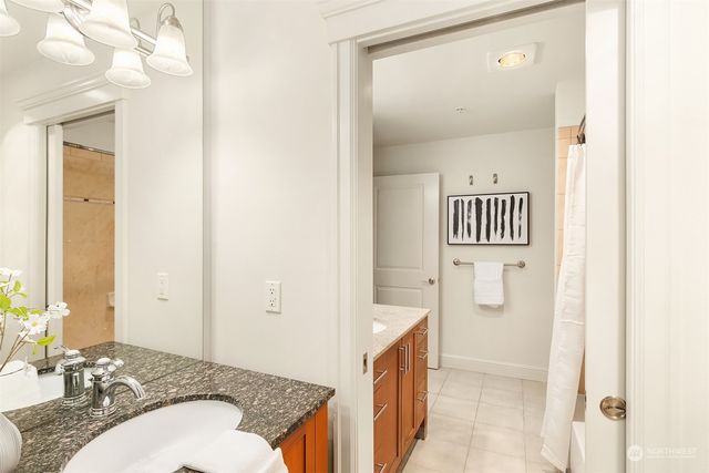a spacious bathroom with a granite countertop sink and a mirror