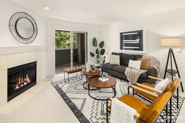 a living room with furniture a table and a fireplace