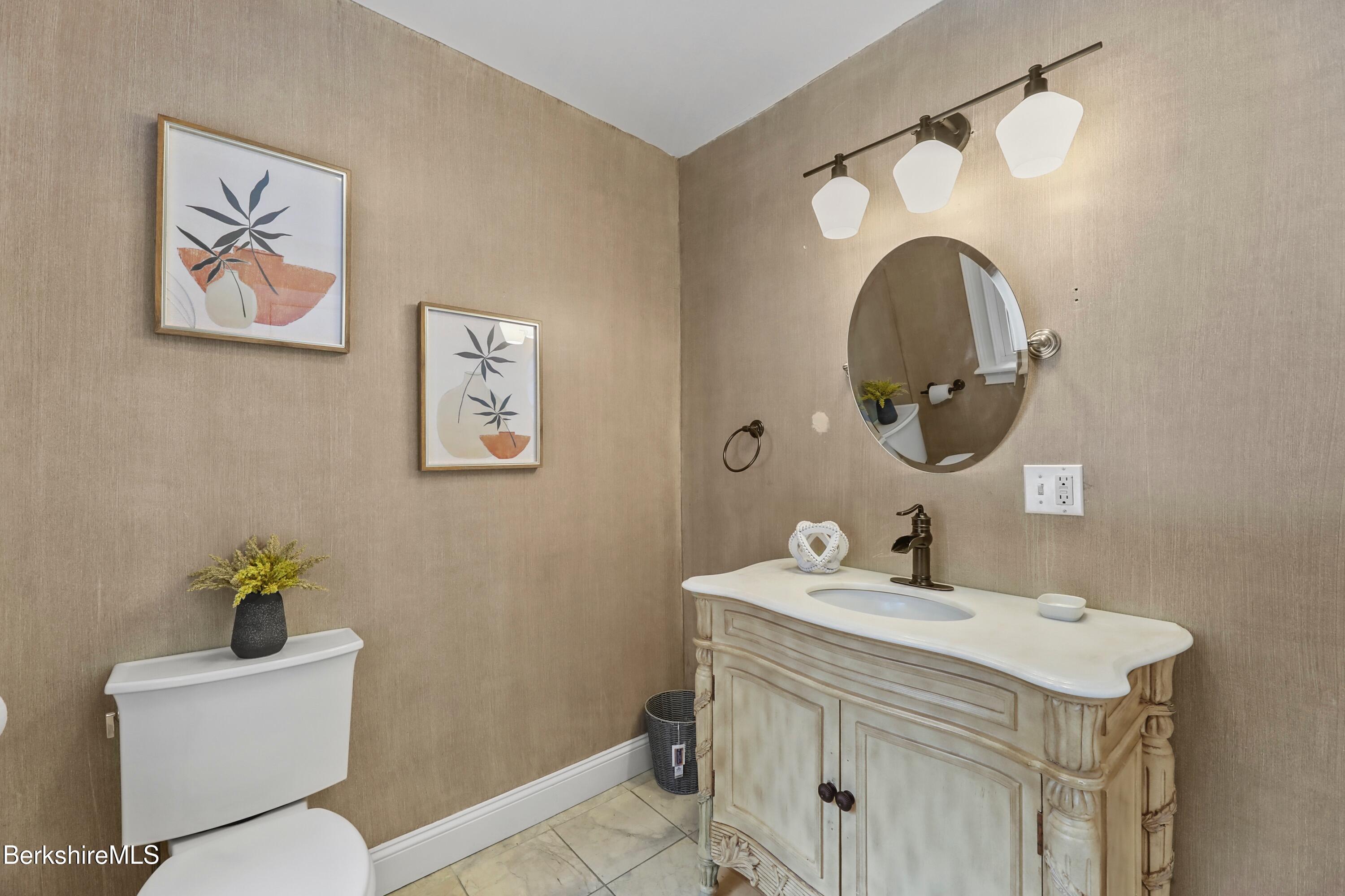 1 Devon Road Stockbridge, MA 01262 - Photo 40 of 58 a bathroom with a toilet a sink and mirror